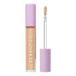 Tower 28 Beauty Swipe Serum Concealer in the shade 9.0 MDR, shown with the tube standing upright next to the open applicator wand to reveal the product. [9.0 MDR]