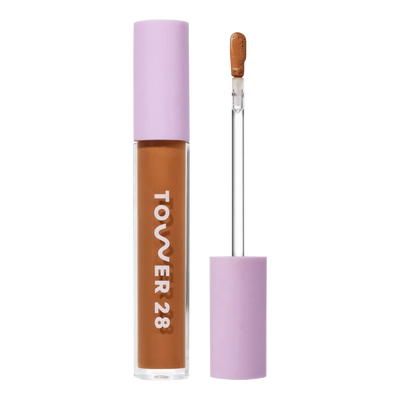 Tower 28 Beauty Swipe Serum Concealer in the shade 15.0 SAMO, shown with the tube standing upright next to the open applicator wand to reveal the product. [15.0 SAMO]