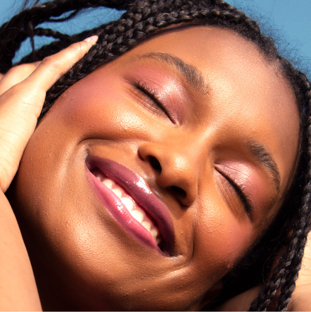 A model wearing the Tower 28 Beauty ShineOn Lip Jelly in the shade Sesame on her lips. [Sesame]