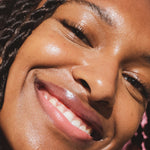 A model wearing the Tower 28 Beauty ShineOn Lip Jelly in the shade Pistachio on her lips. [Pistachio]